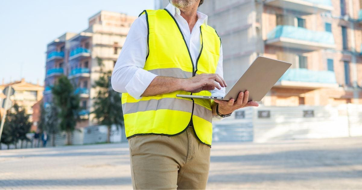 Construction accounting software open on a laptop in a site office