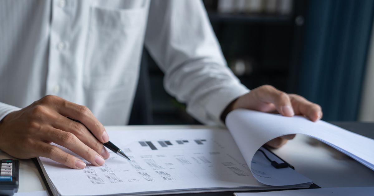 Business owner organising records and contracts to prepare their business for sale