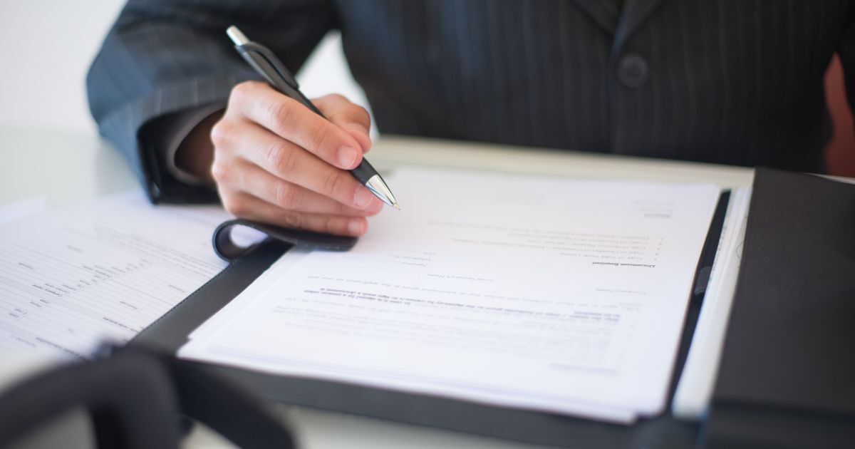 Office manager reviewing company documents, illustrating business continuity planning if a limited company director dies